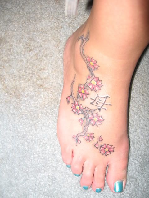 cherry blossom tattoo on foot. along with cherry blossoms